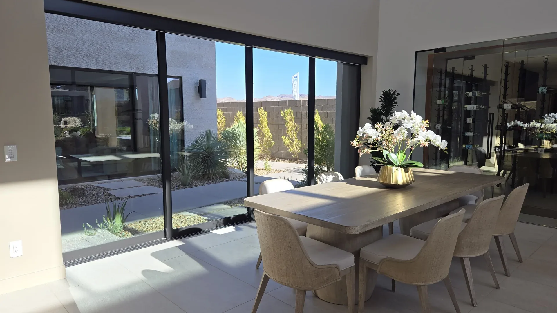 Black-framed sliding glass patio doors beside a dining area
